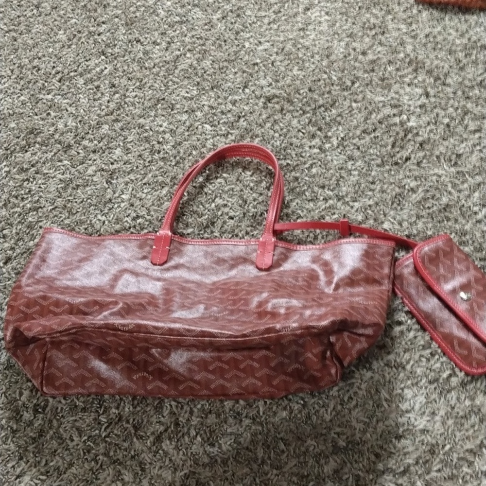 A red and cream colored E Goyard Tote and matching wallet.